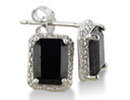 These earrings are completely modern and chic. Each earring boasts a fabulous 2 carat black sapphire emerald cut stone surrounded in diamond accents. Total gem weight is 4 carats, and diamond content is .01 carats carats. Set in sterling silver, these earrings will make every woman glow. Diamond color is J-K and diamond clarity is I2-I3. One star diamonds.