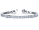 Diamond tennis bracelets are the epitome of elegance and class.  This beautiful tennis bracelet boast 65 princess cut diamonds set in solid 14 karat white gold at a total weight of 6 1/2 carats.  Diamond color is G/H, diamond clarity is I1.  Bracelet fits a 7-8 inch wrist.